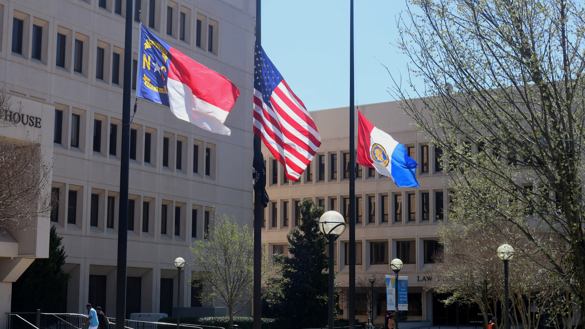three flags against blue sky