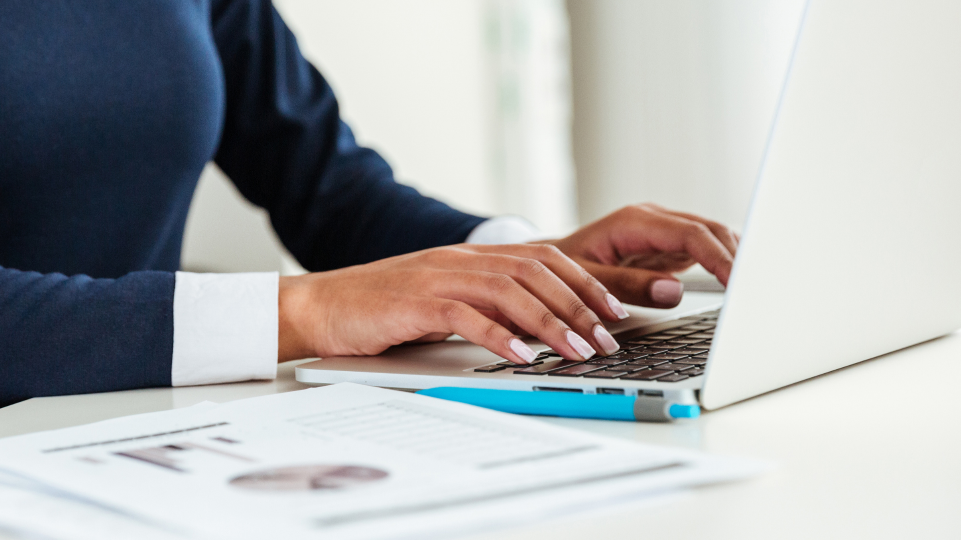Close up of hands typing on a laptop,