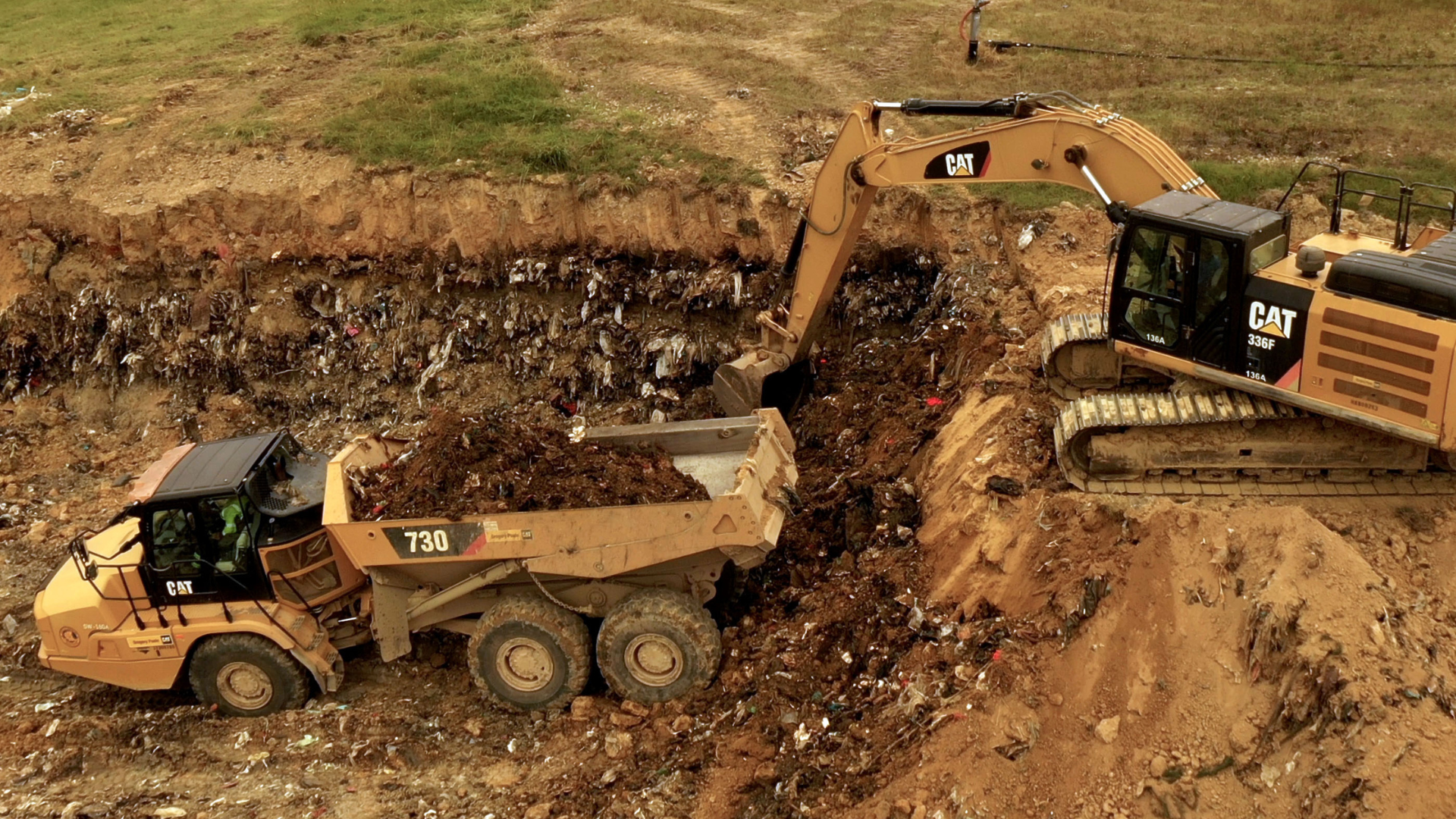 construction equipment digging in a landfill
